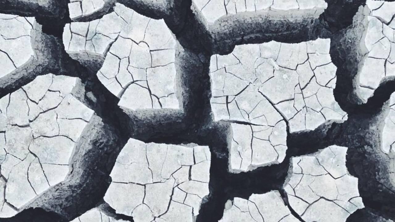 Dry, cracked ground in black and white