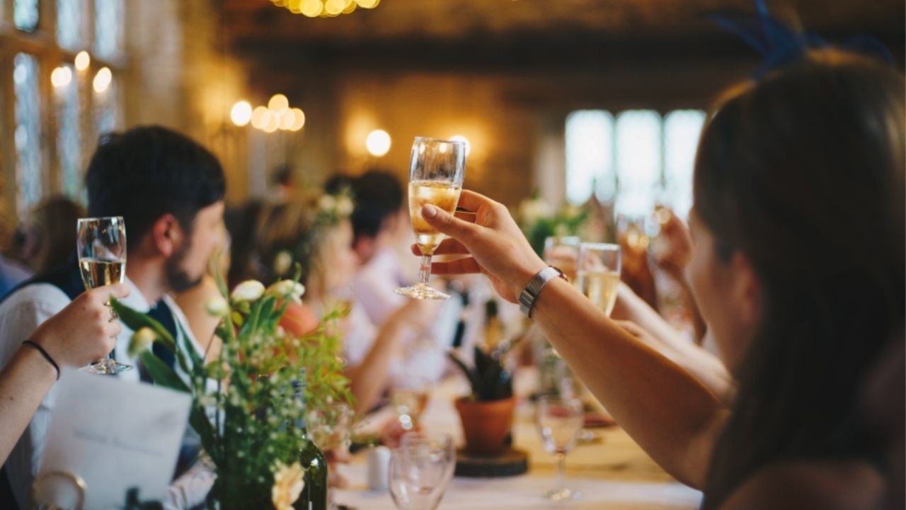 Guests at holiday dinner raising glasses for a toast