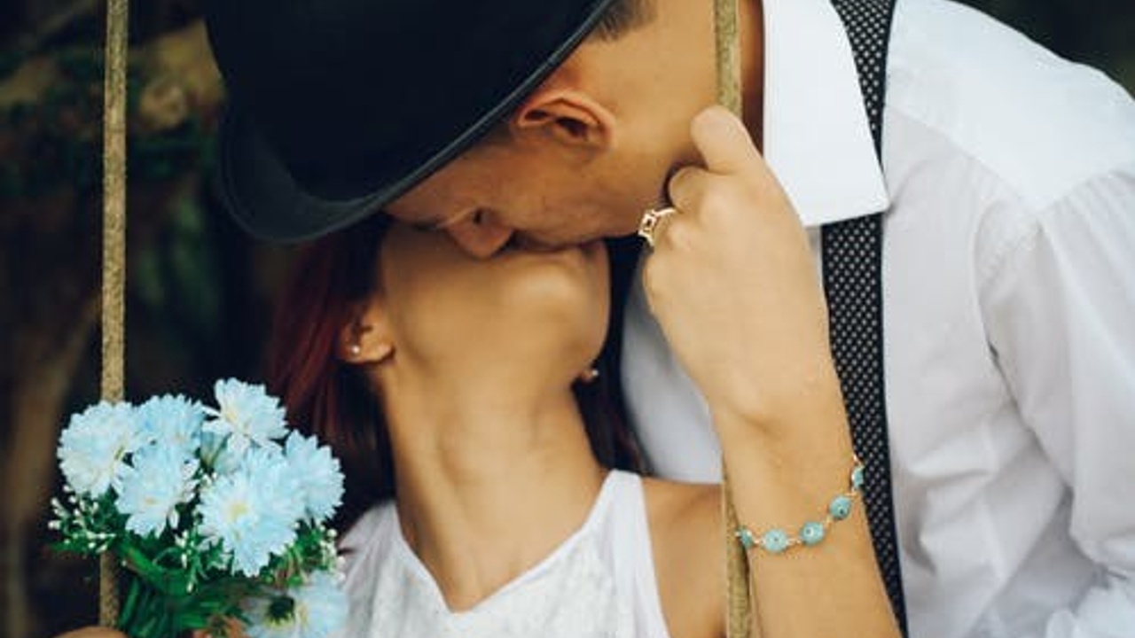 man kissing his wife in wedding party
