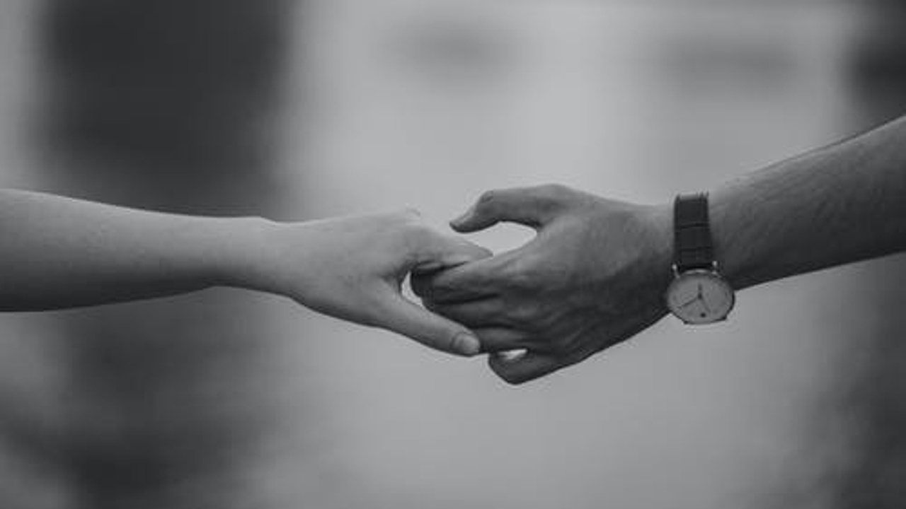 a couple hands in hand