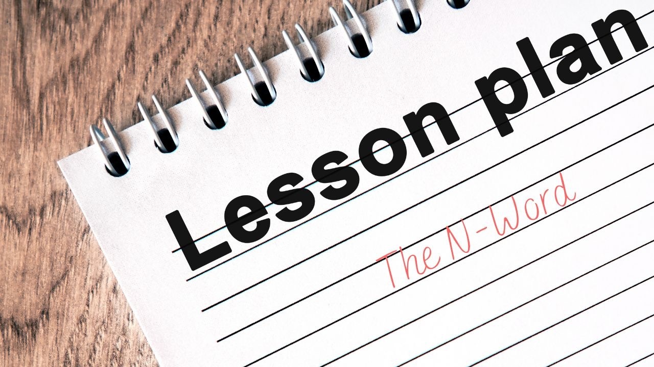 A wooden desk with a notepad on it and the words "Lesson plan" at the top. Below that title, in red, is "The N-Word" in a handwritten style.