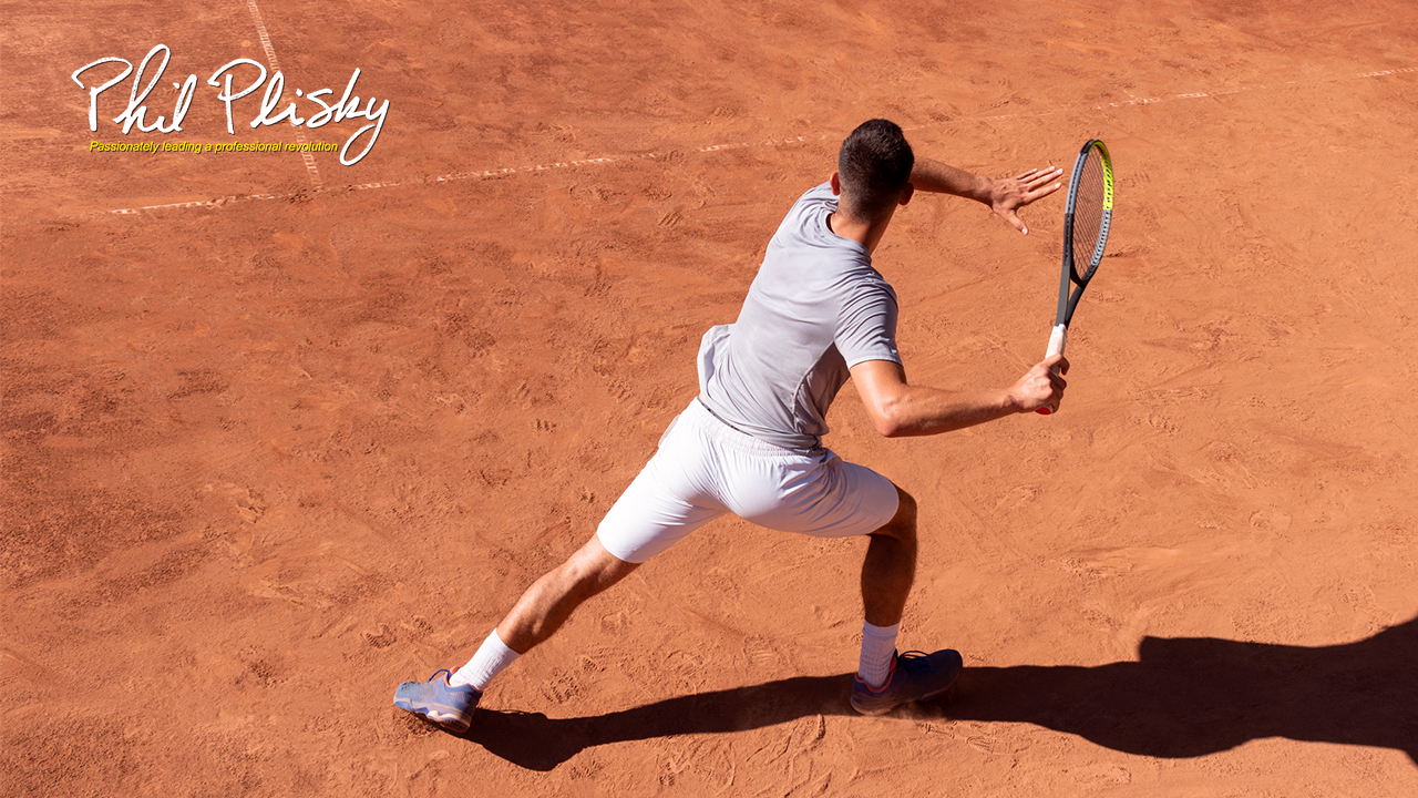 Professional tennis player performs forehand hit on clay tennis court. Young male athlete with tennis racket in action. Junior tennis sport. Back view, shadow, copy space stock photo