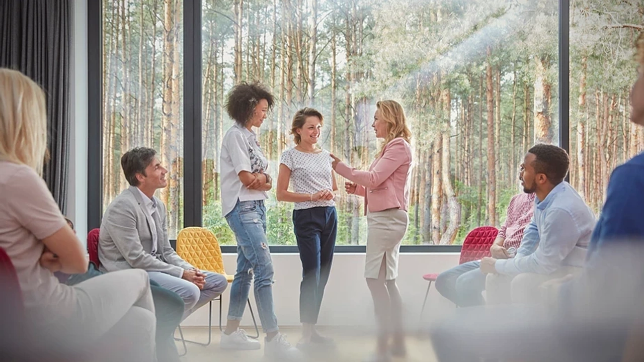 women standing and talking at a meeting