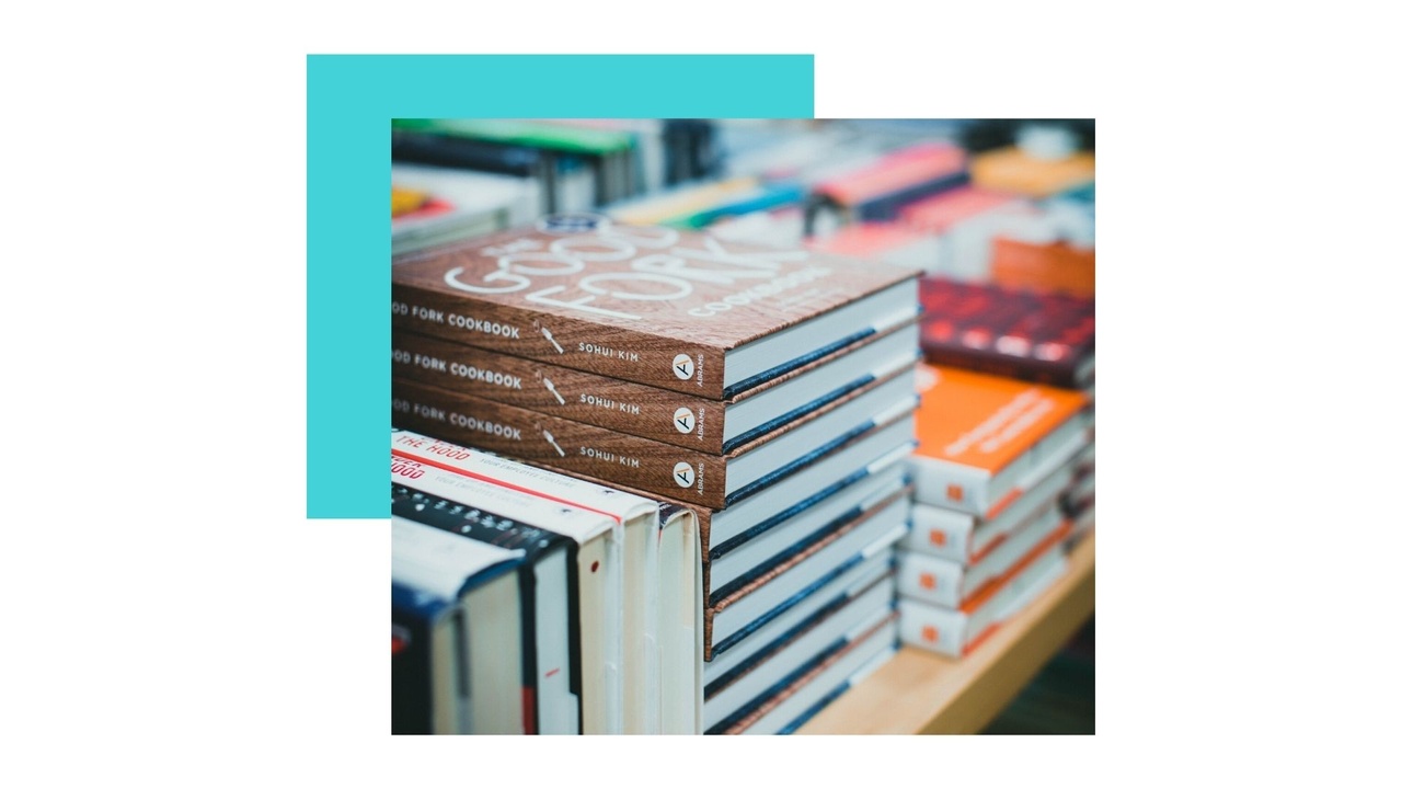 books piled on a bookstore table