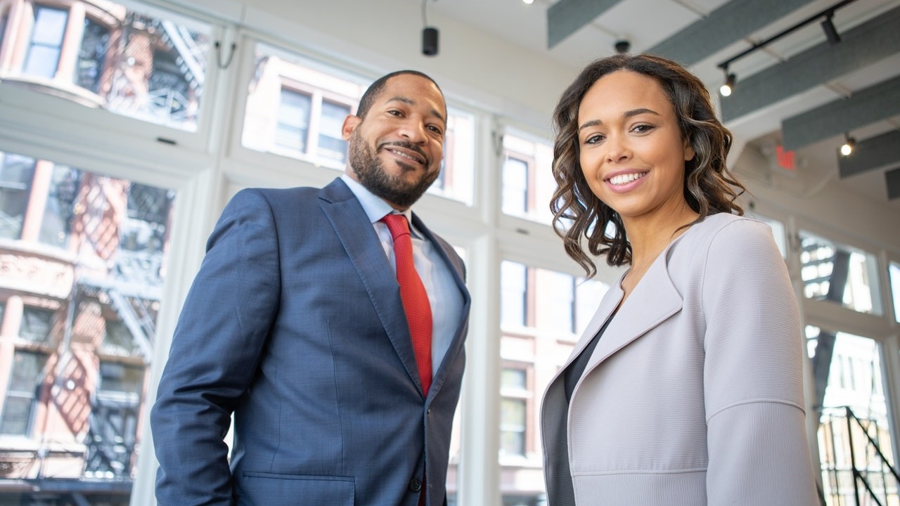 Man and Woman Smiling Inside Building