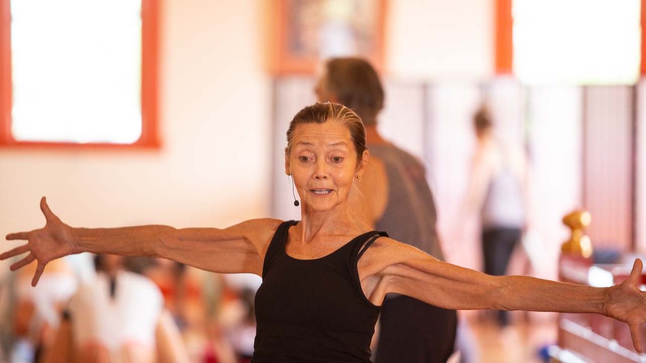 woman yoga teacher with open arms