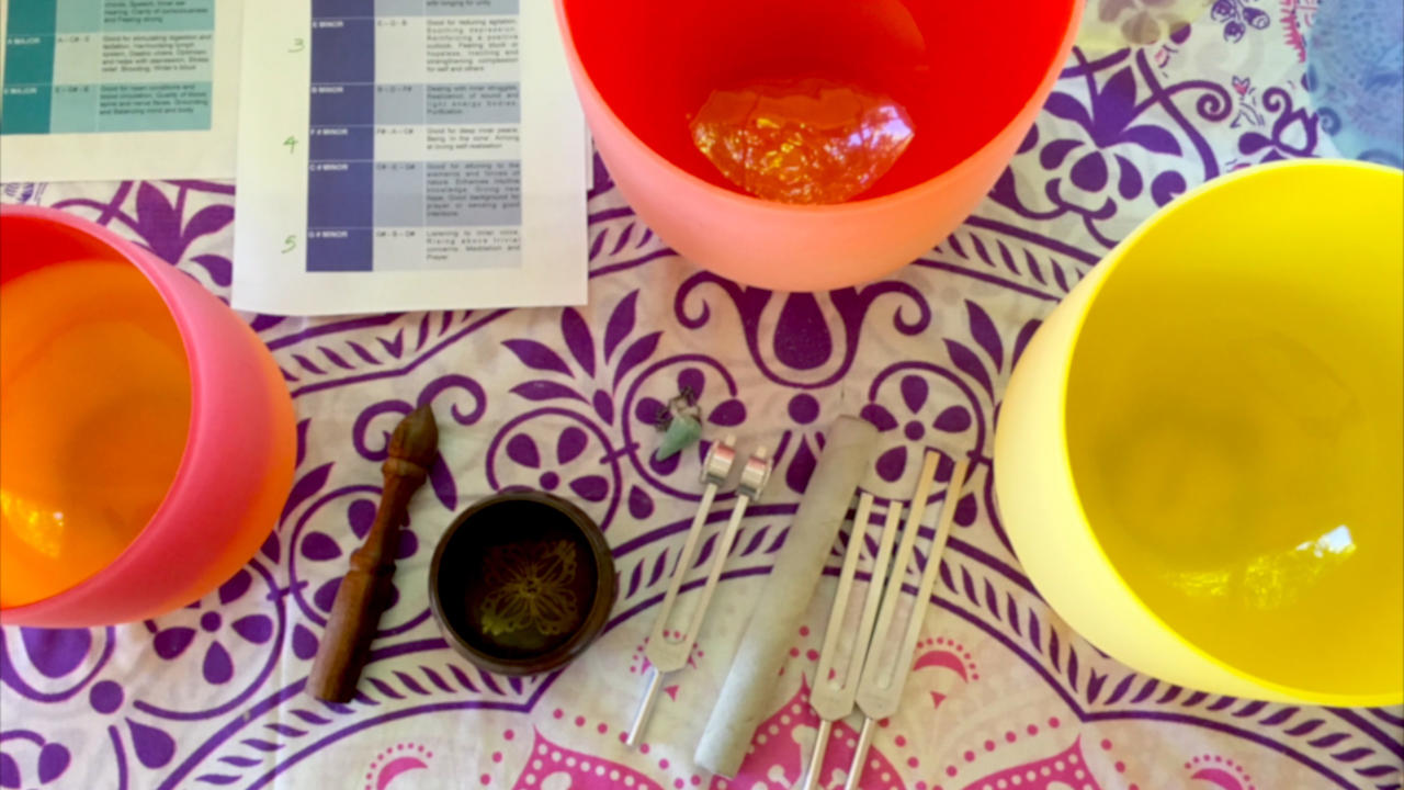 Colourful crystal singing bowls on a patterned mat