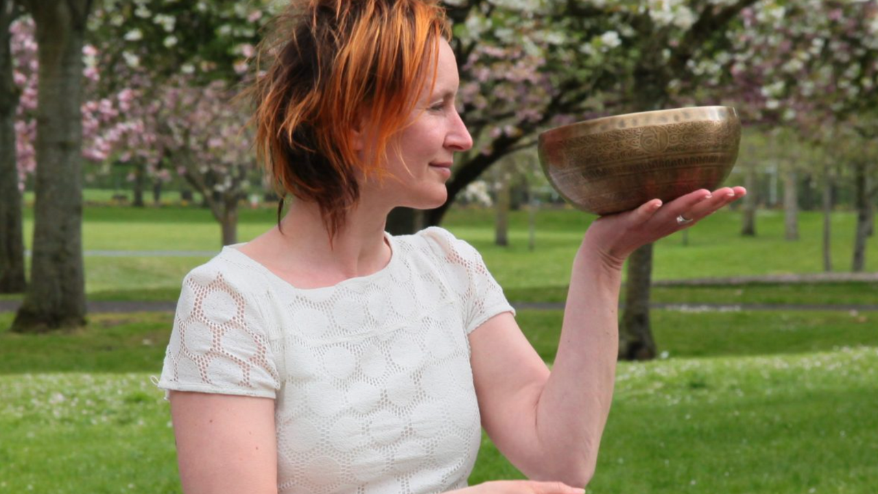 Sound Healing Practitioner holding a Tibetan singing bowl