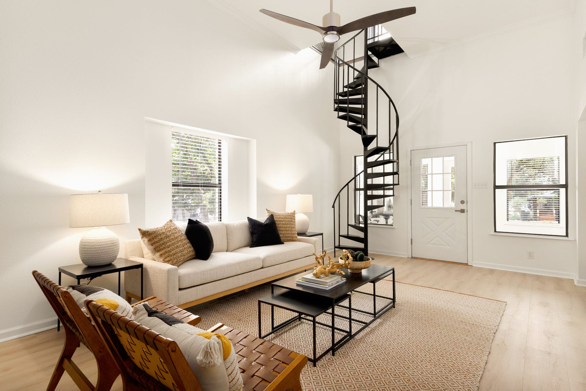 Main living room with 13-foot ceilings and spiral staircase.