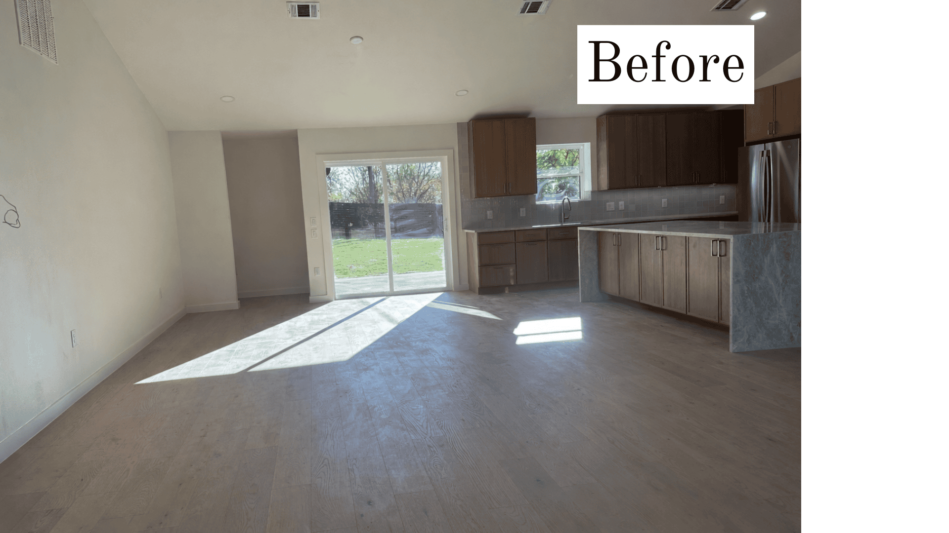 A spacious, unlit open-concept room labeled