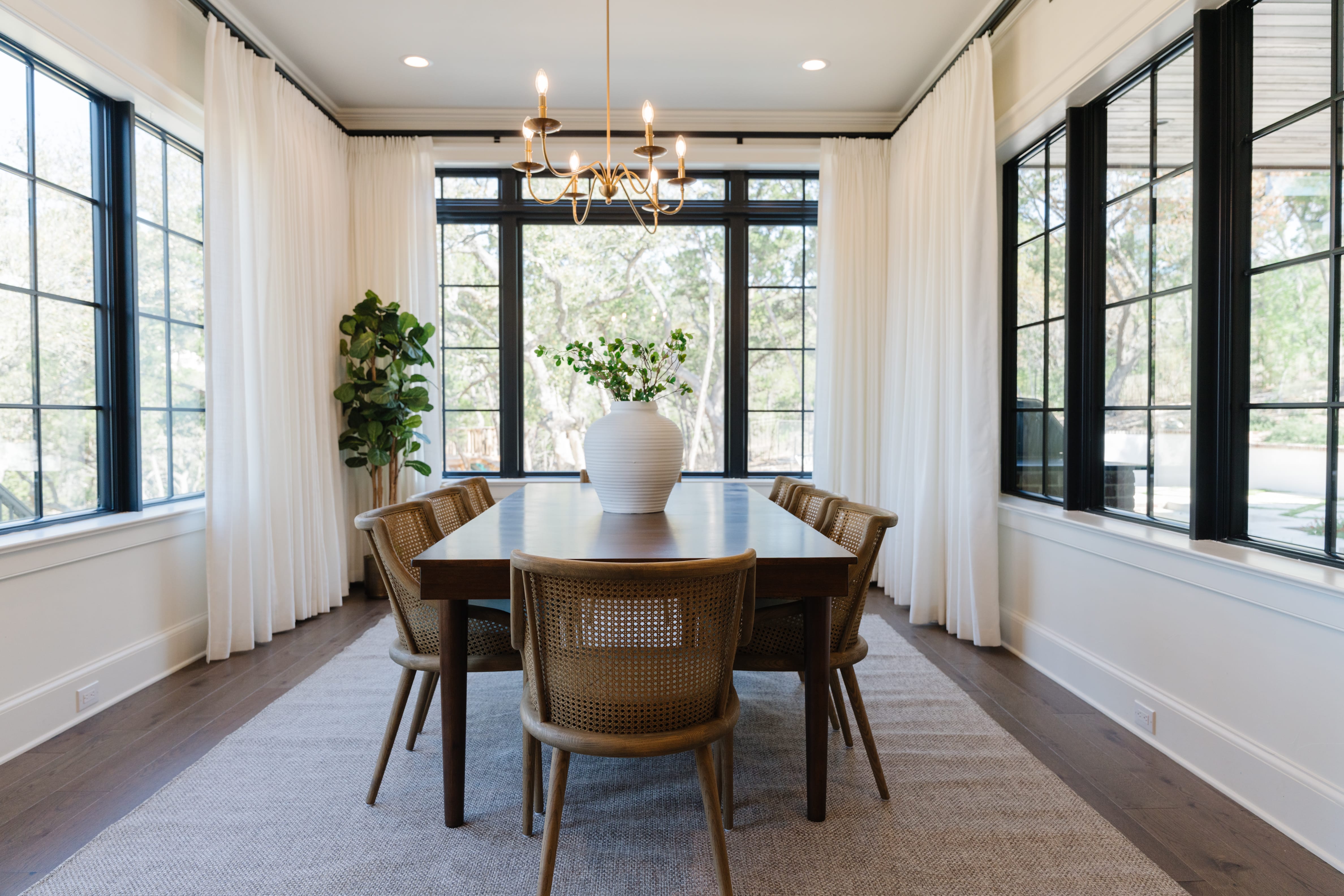 Large dining area with table for eight adjacent to the kitchen.