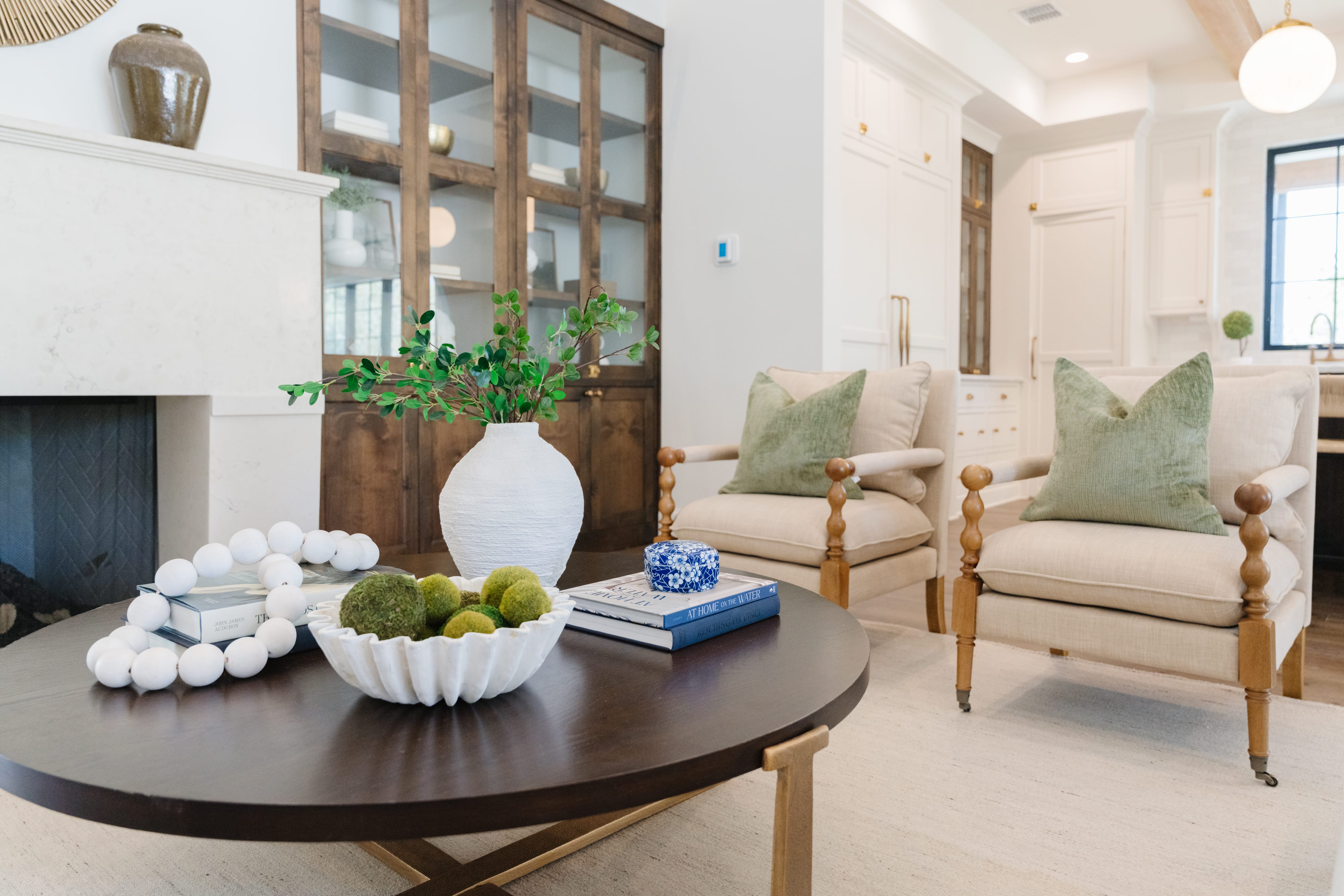 Muted upholstery with toile and velvet textures and gently curved furniture.