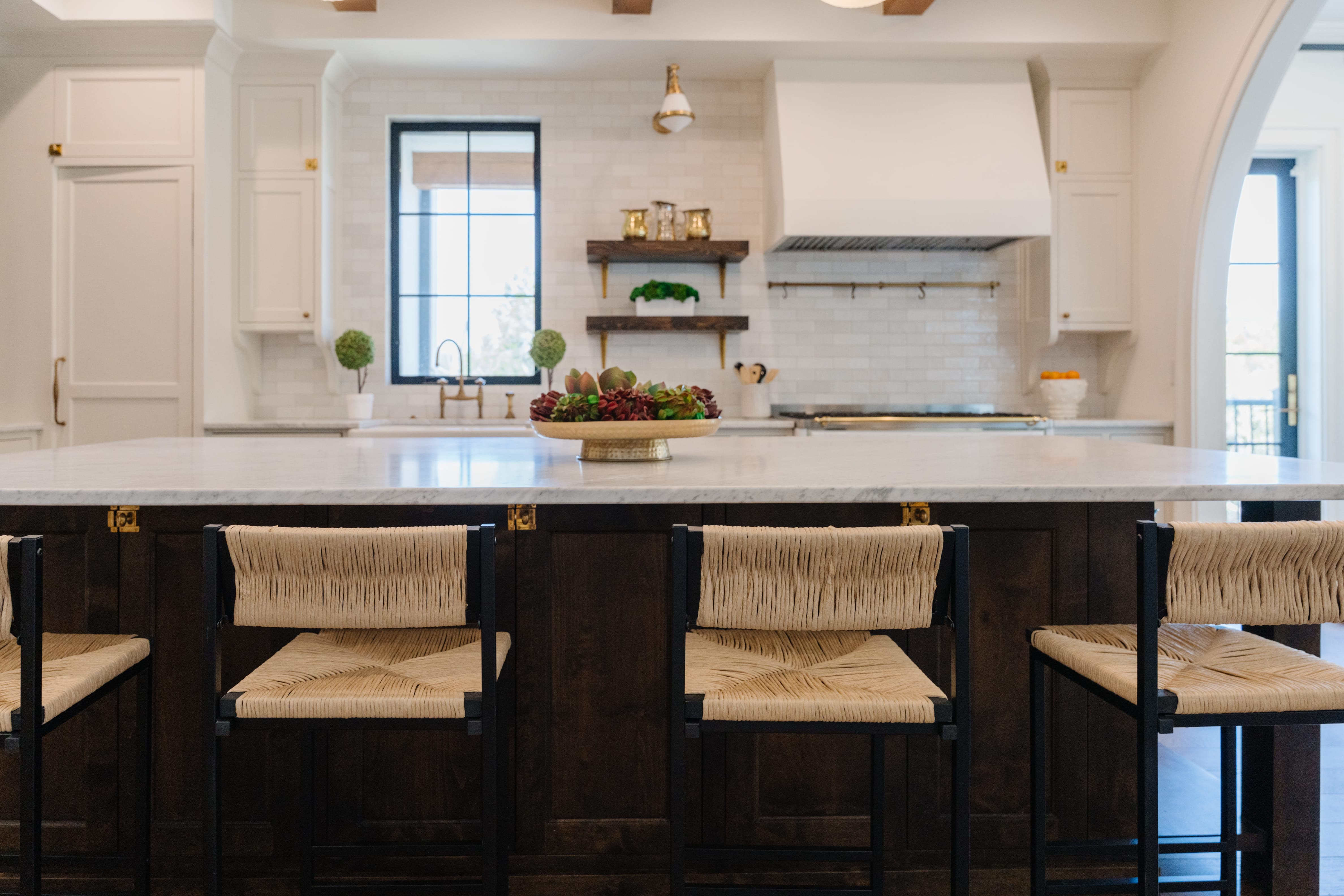 Kitchen with oversized island and seating for four barstools.
