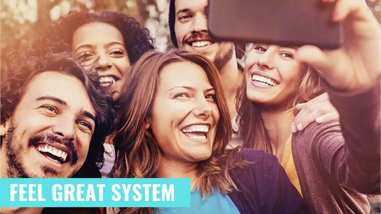 A group of young millennials smiling and having fun taking a selfie with the text overlay 'Feel Great System' on the image. The image shows people enjoying the benefits of the Feel Great System and promotes a healthy lifestyle.