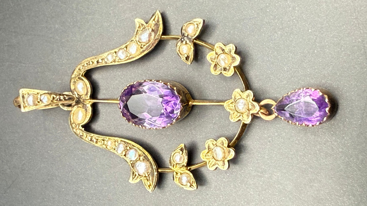 Full pendant showing amethyst drops and delicate floral motif.
