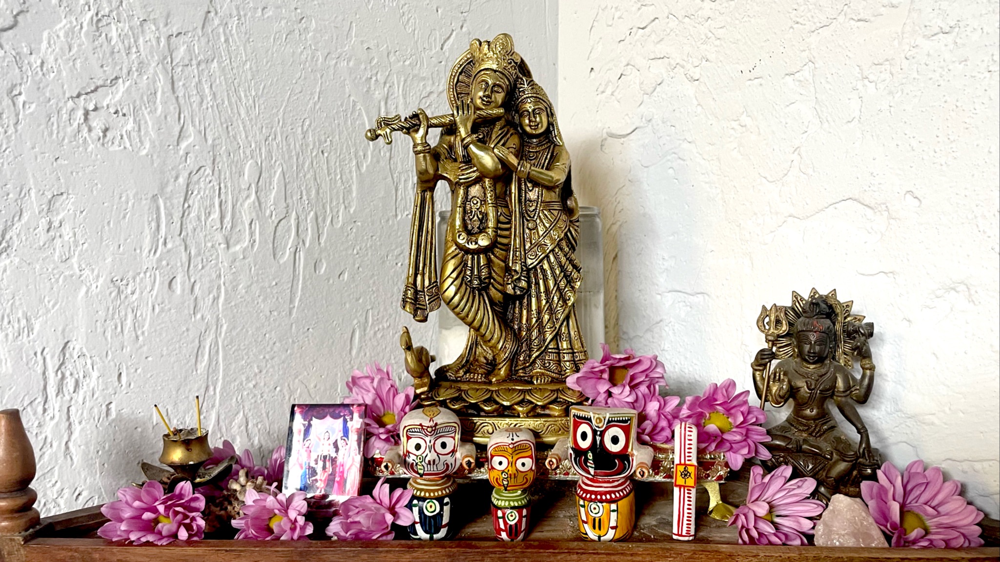 Shiva and Shakti on a wooden altar along with the triad of Lord Jagannath (Krishna), Balarama (or Balabhadra), and Subhadra