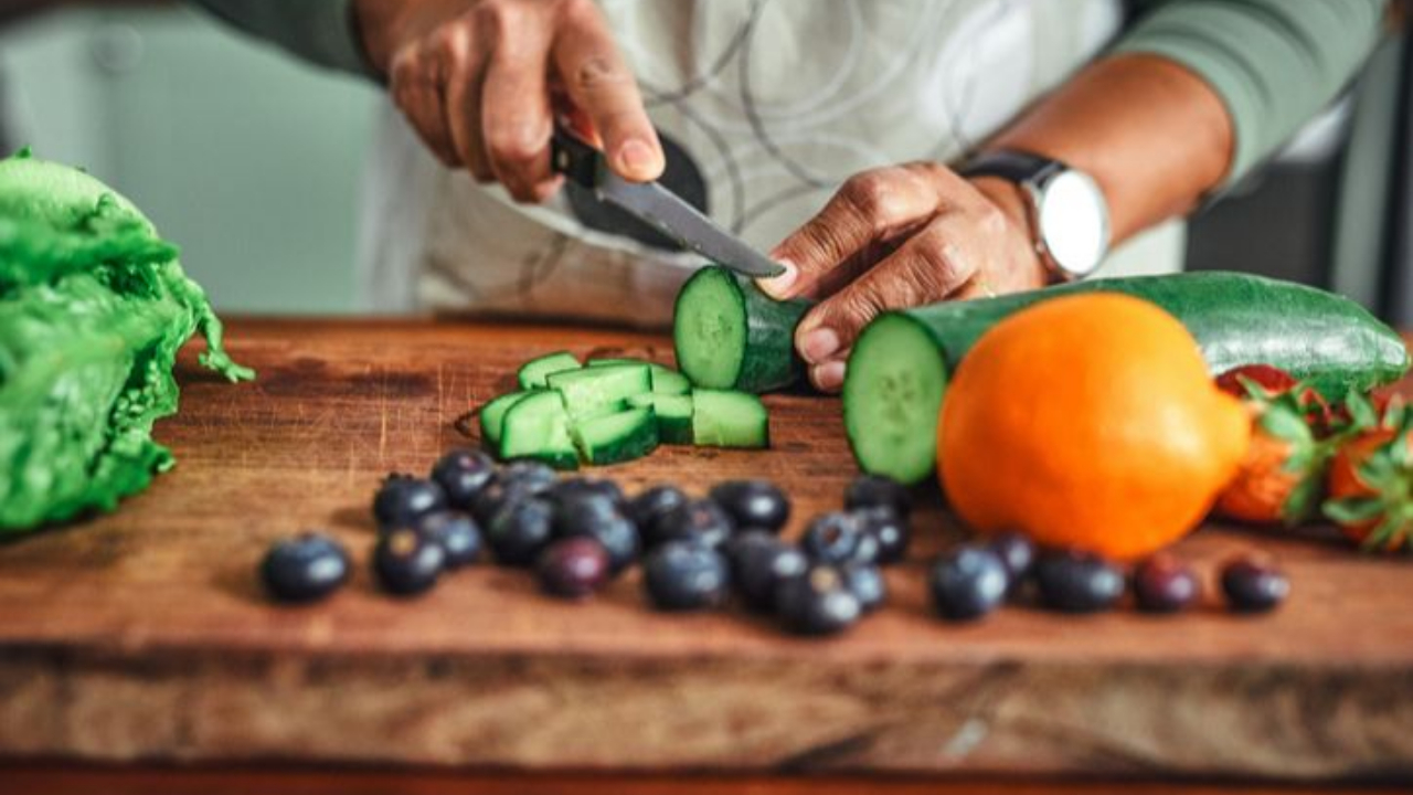 Chopping cucumbers with beans in foreground