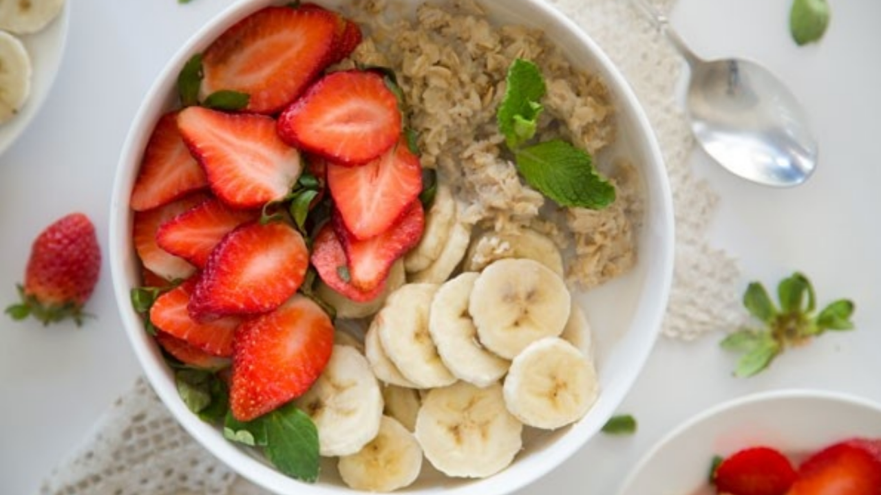 bowl of oatmeal with bananas and strawberries
