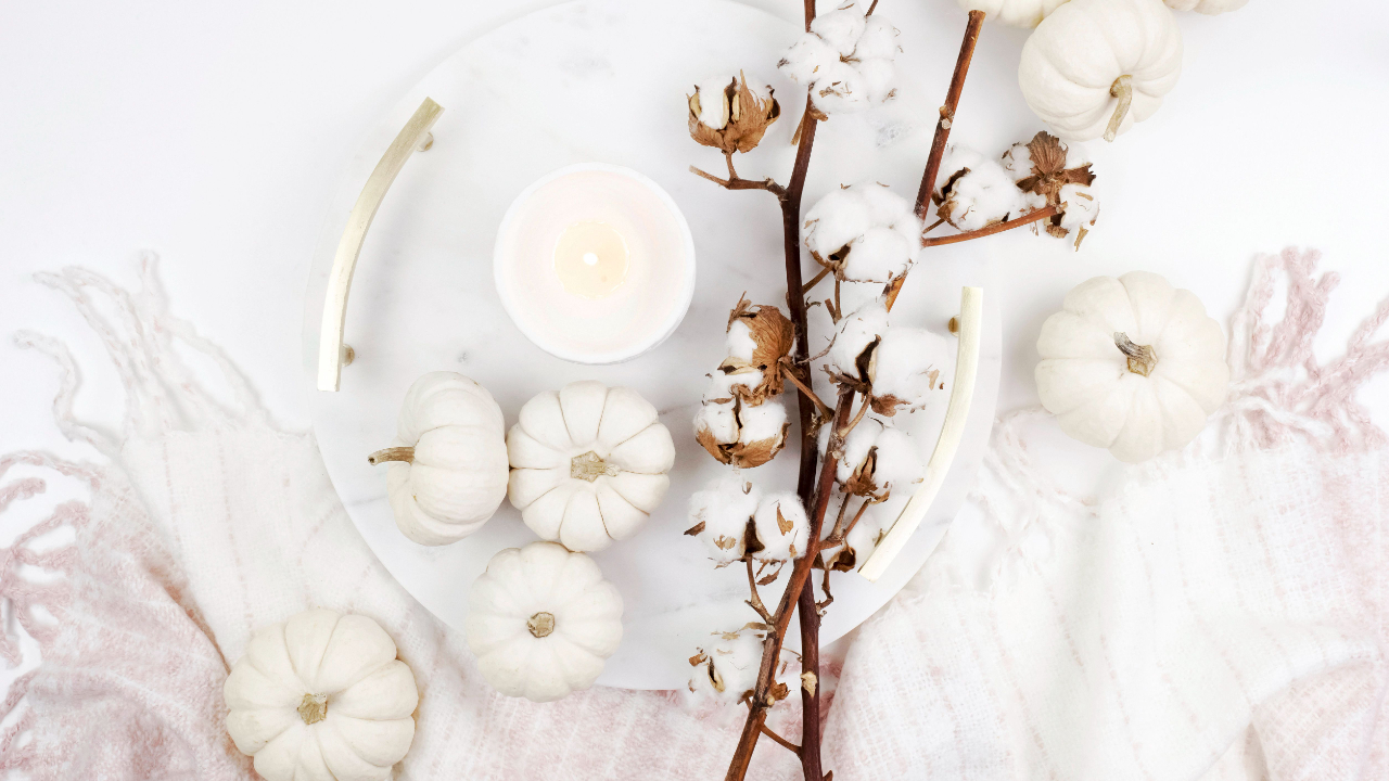 Image of candle and white pumpkins representing inner autumn