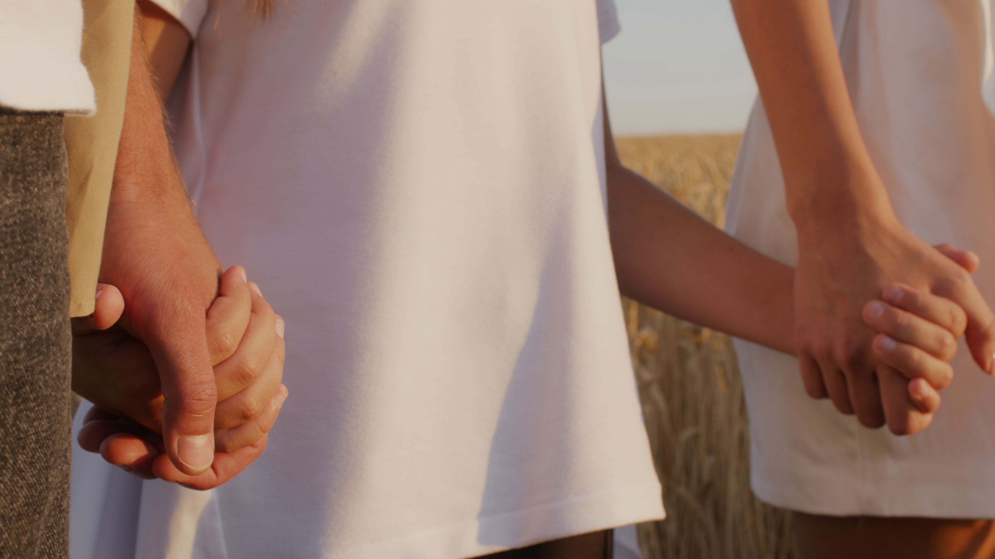 A child holding hands with her parents.