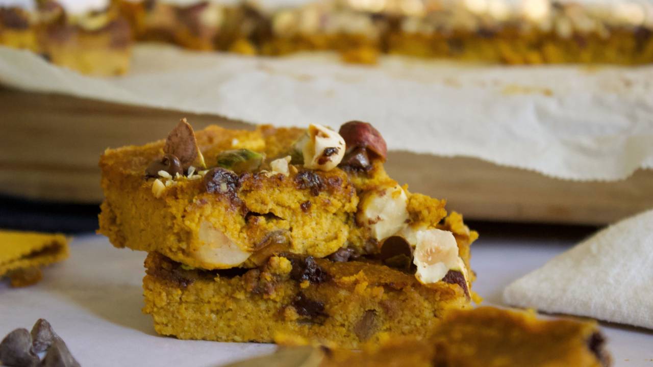 Delicious Vegan and Gluten Free Pumpkin Bars or Squares with Chocolate Chips and Crunchy Pistachios and Hazelnut Topping