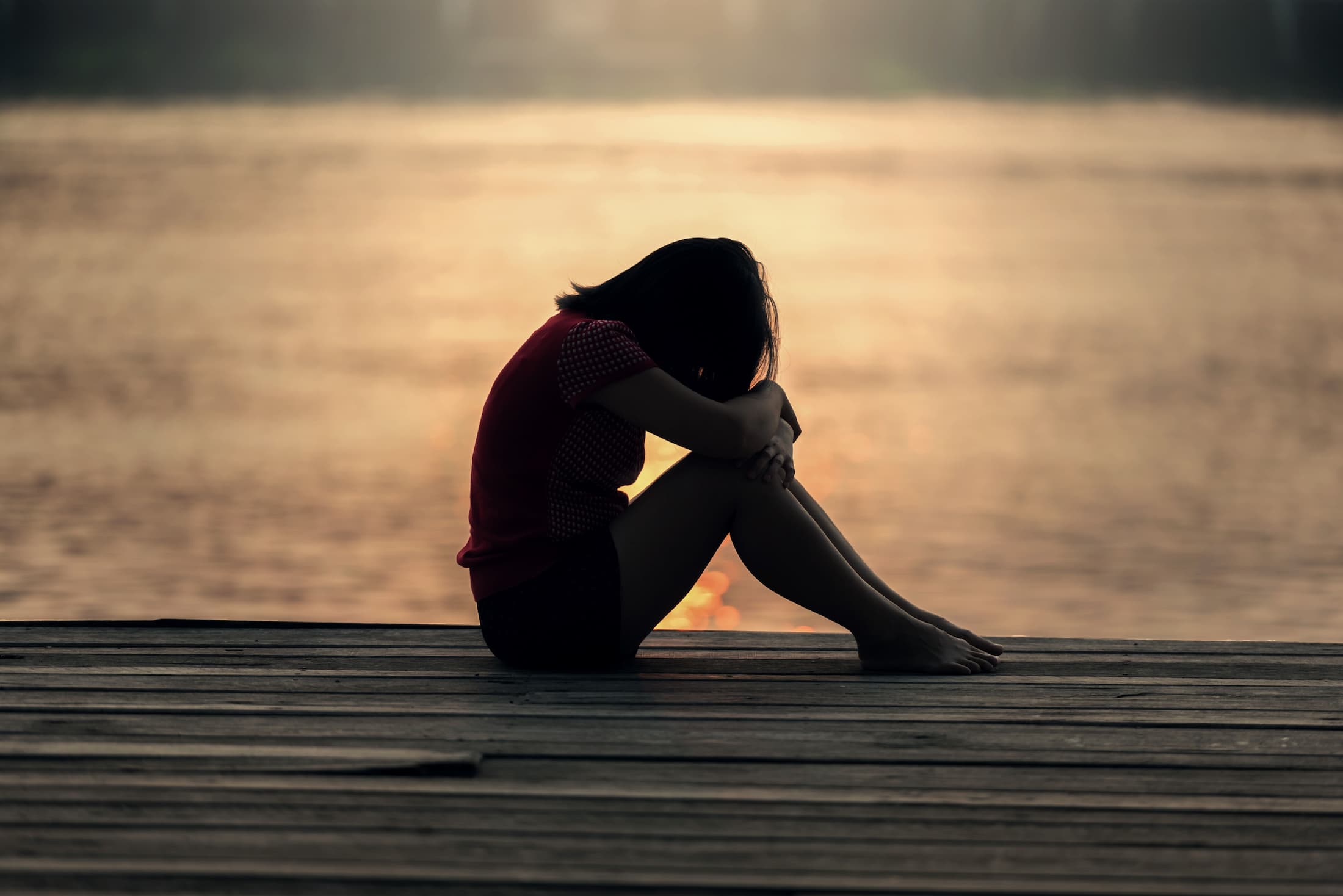 A person sitting with grief, contemplative moment