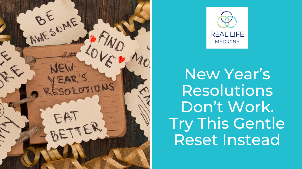 A notebook page labelled “New Year’s Resolutions” is surrounded by decorative tags with handwritten goals such as “Be awesome”, “Find love” and “Eat better”, along with gold ribbon on a wooden surface. On the right, a turquoise panel shows the Real Life Medicine logo and the words “New Year’s Resolutions Don’t Work. Try This Gentle Reset Instead” in large white text.