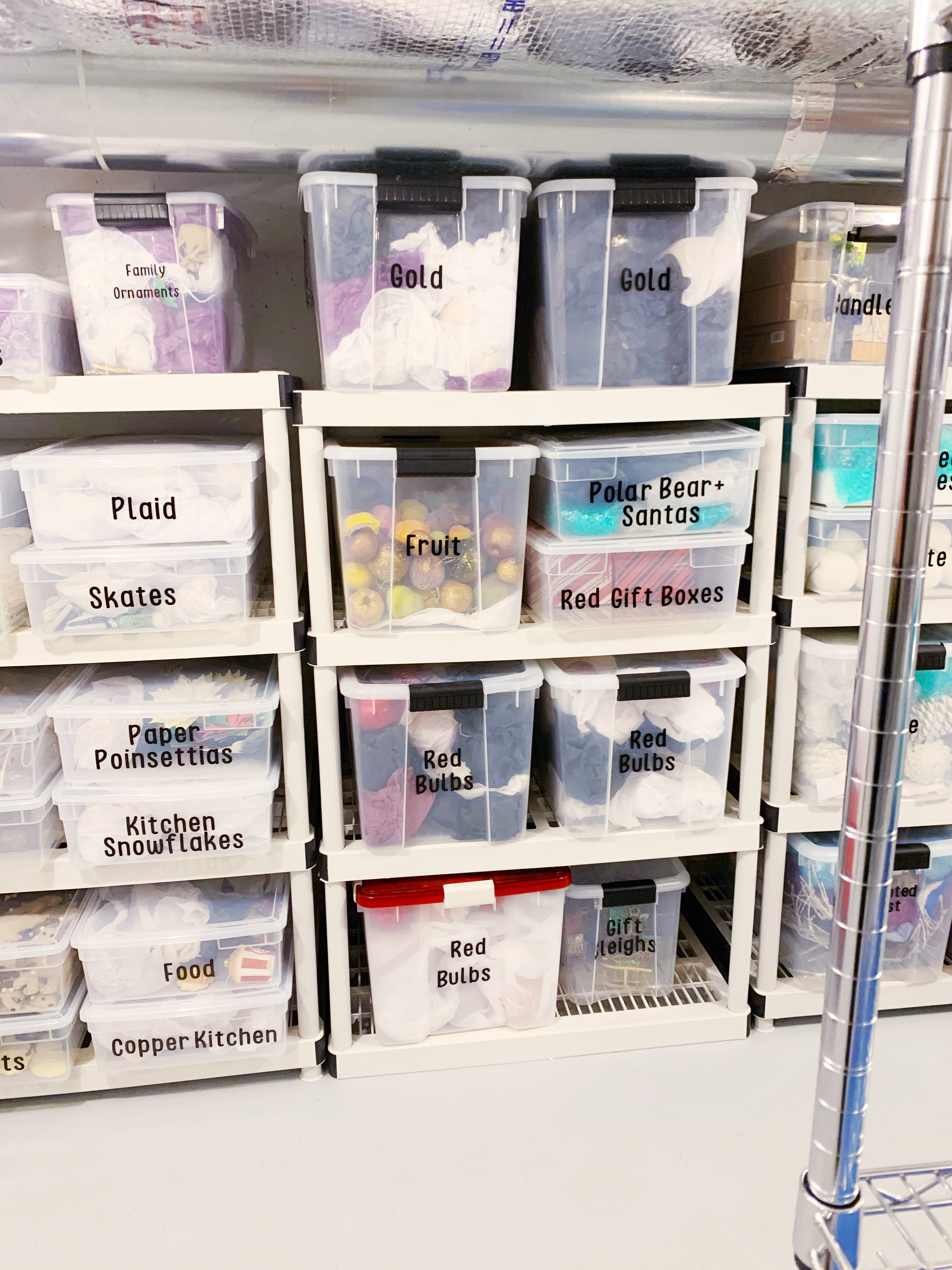 clear, labeled boxes containing beautifully organized holiday decor