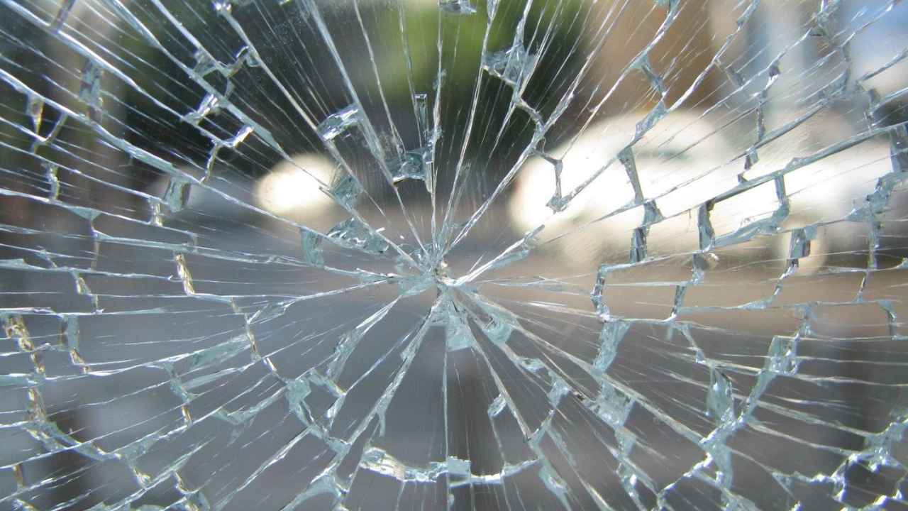 image of street through broken glass