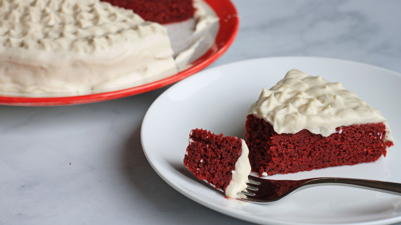 a slice of paleo red velvet cake on a white plate