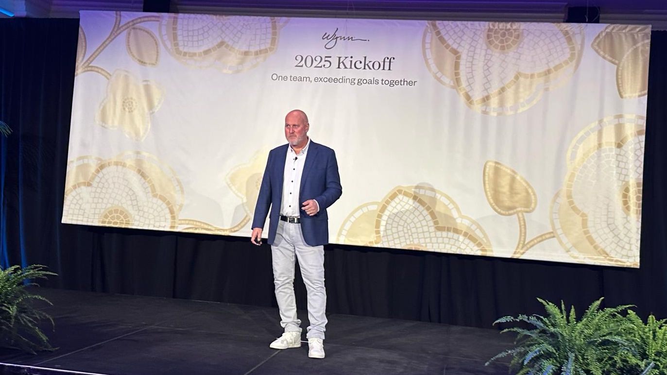 A speaker standing on stage at a 2025 kickoff event presenting about personal accountability and self-discipline