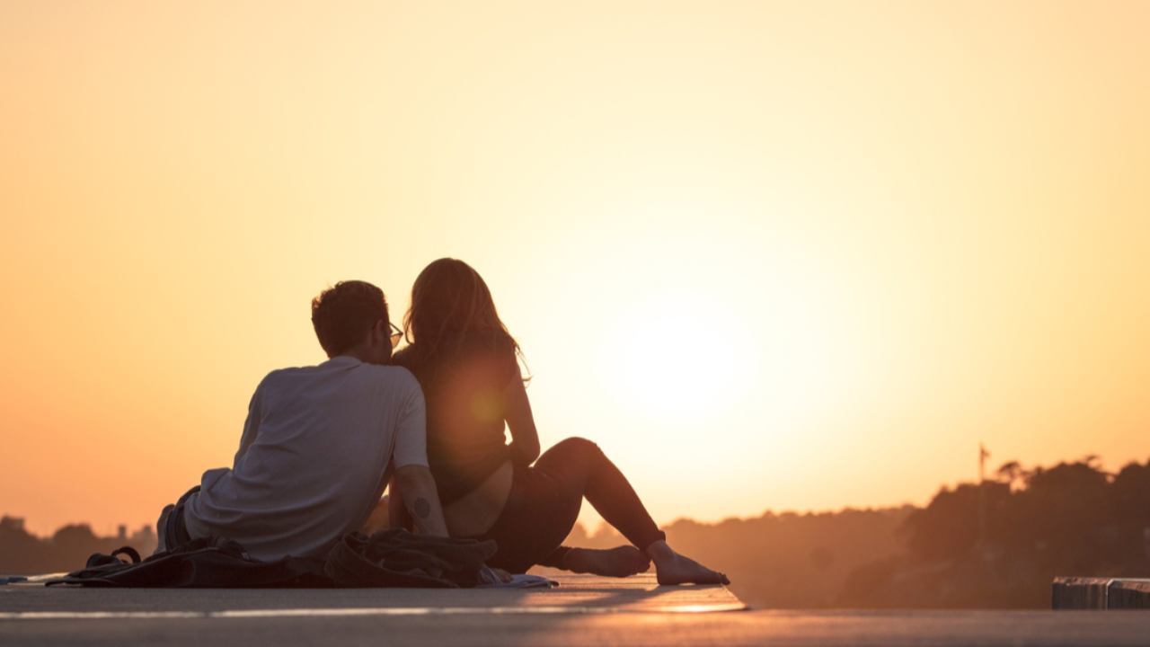 A photo of a couple looking at the sun