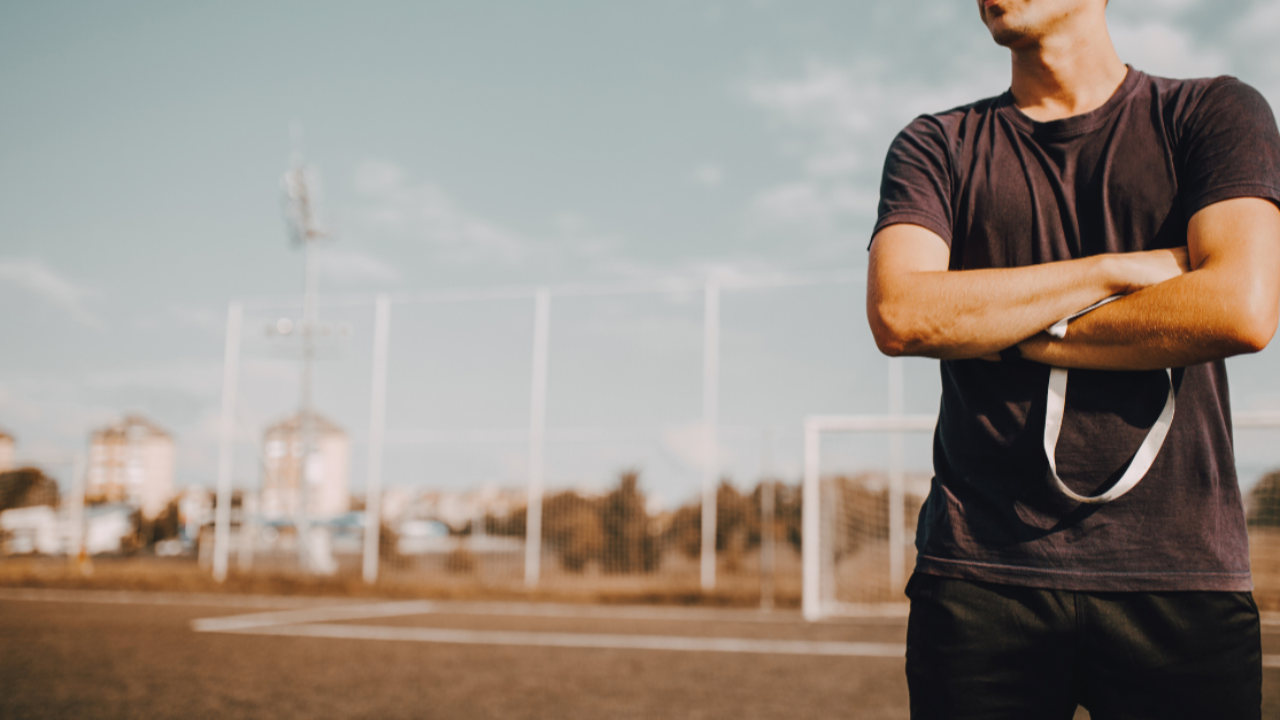 A coach on the field getting ready to mentor his sports team