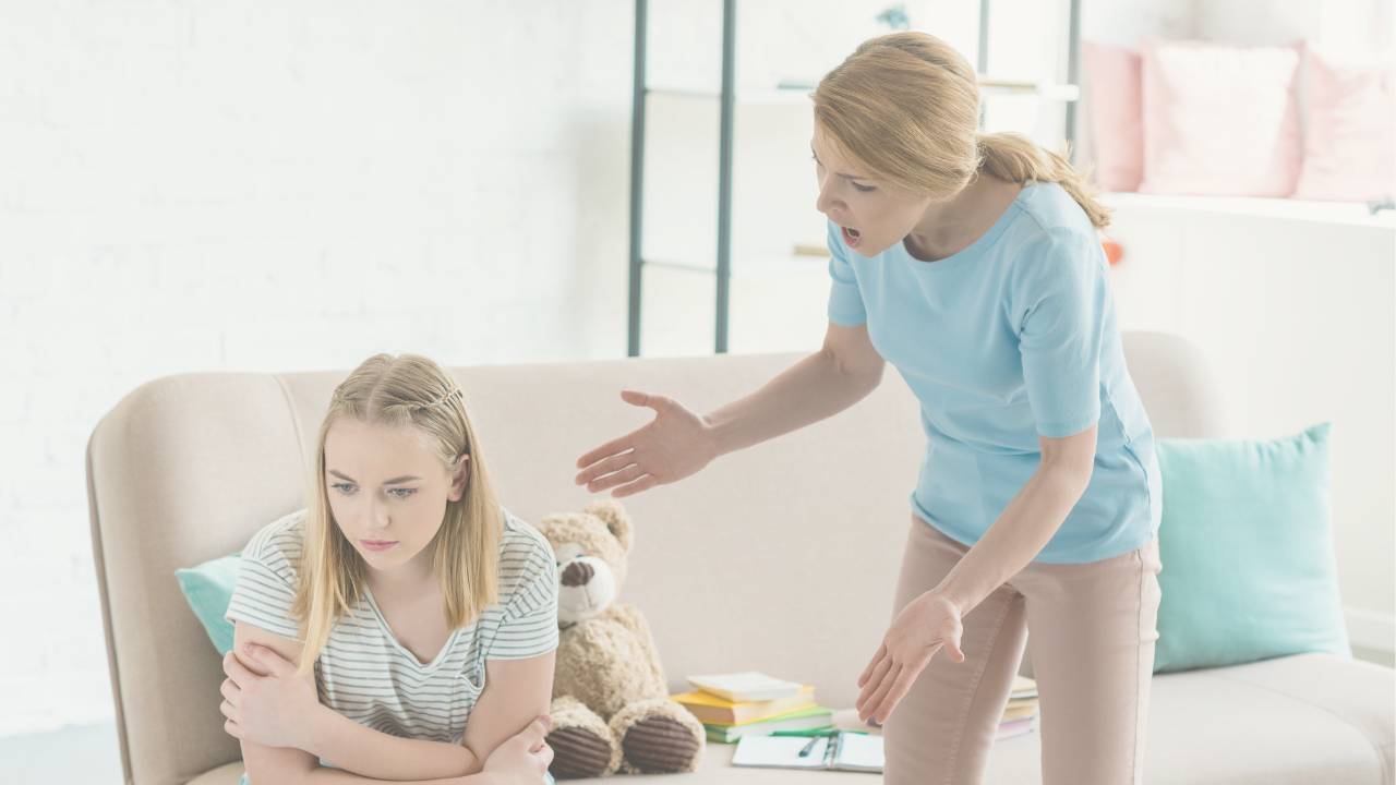 Exasperated mom yelling at her young daughter on the couch — why moms yell and how to stop
