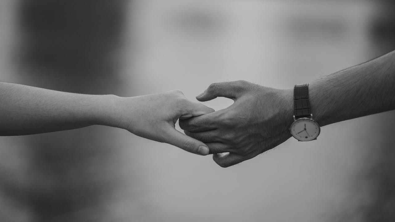 Couple holding hands in a quiet moment of connection and support