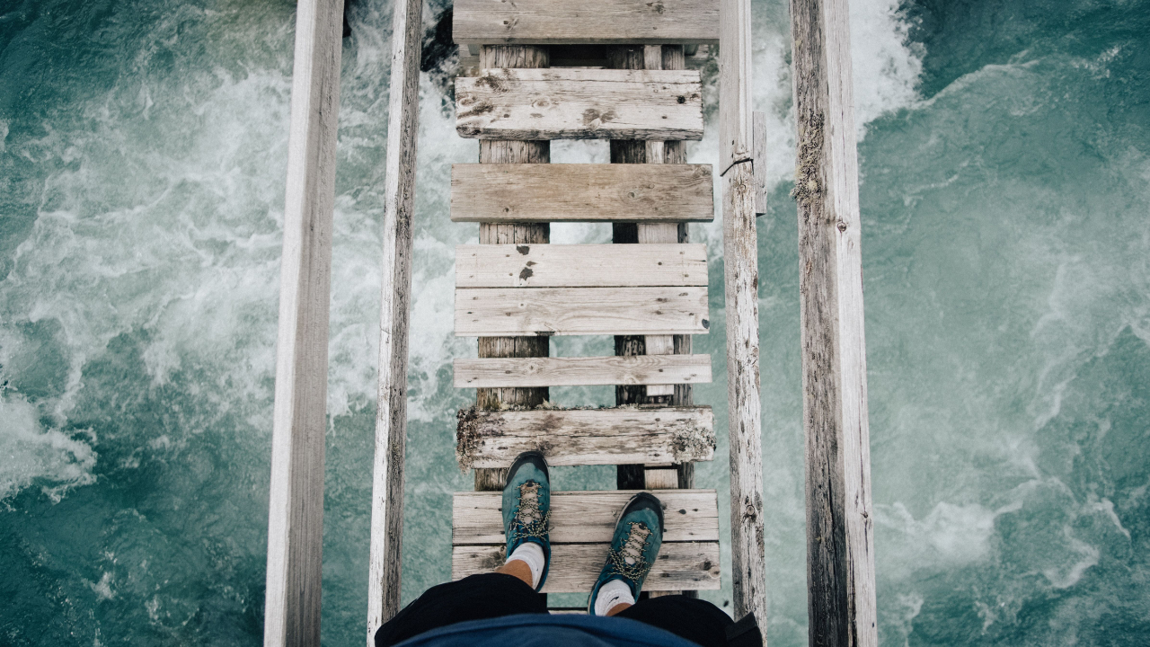 Rickety path over water symbolizing the challenges in building a successful coaching business