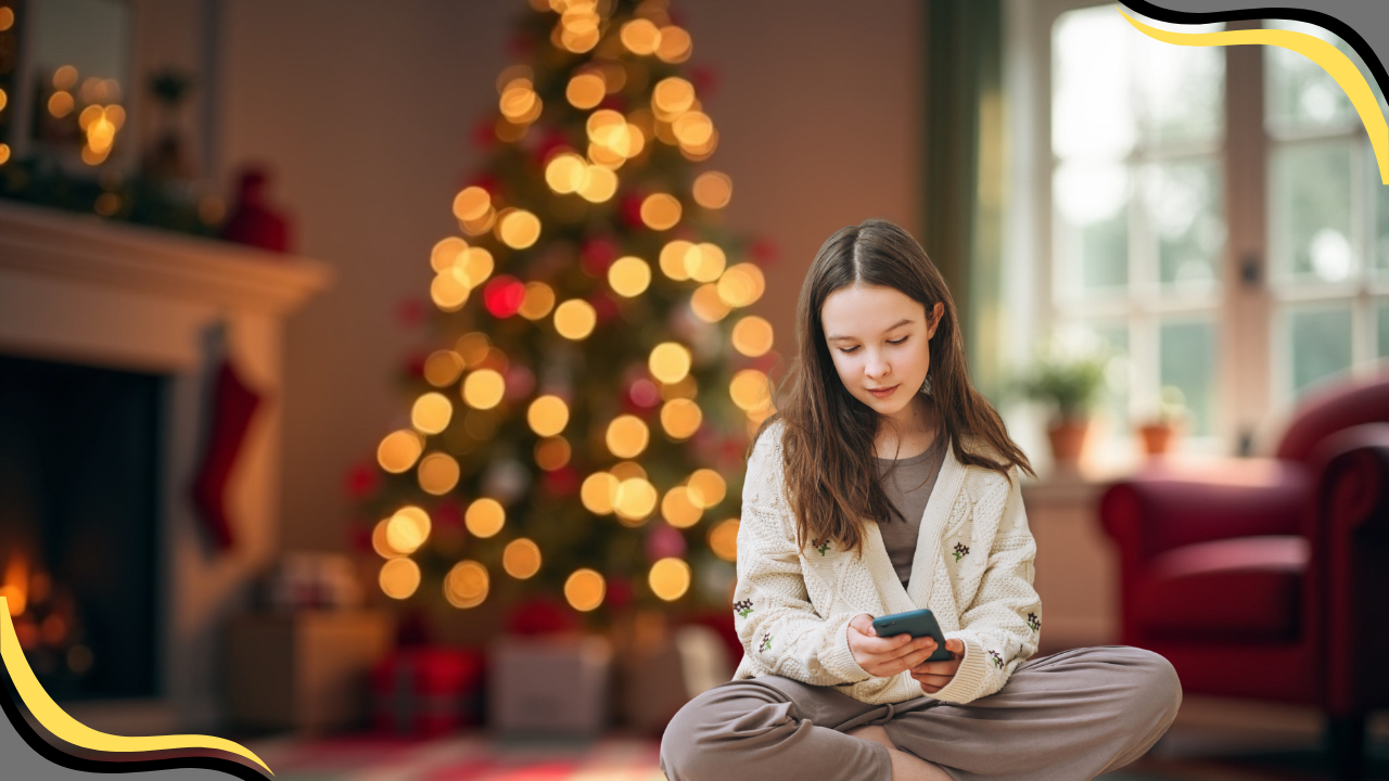 teen on phone in front of a Christmas Tree