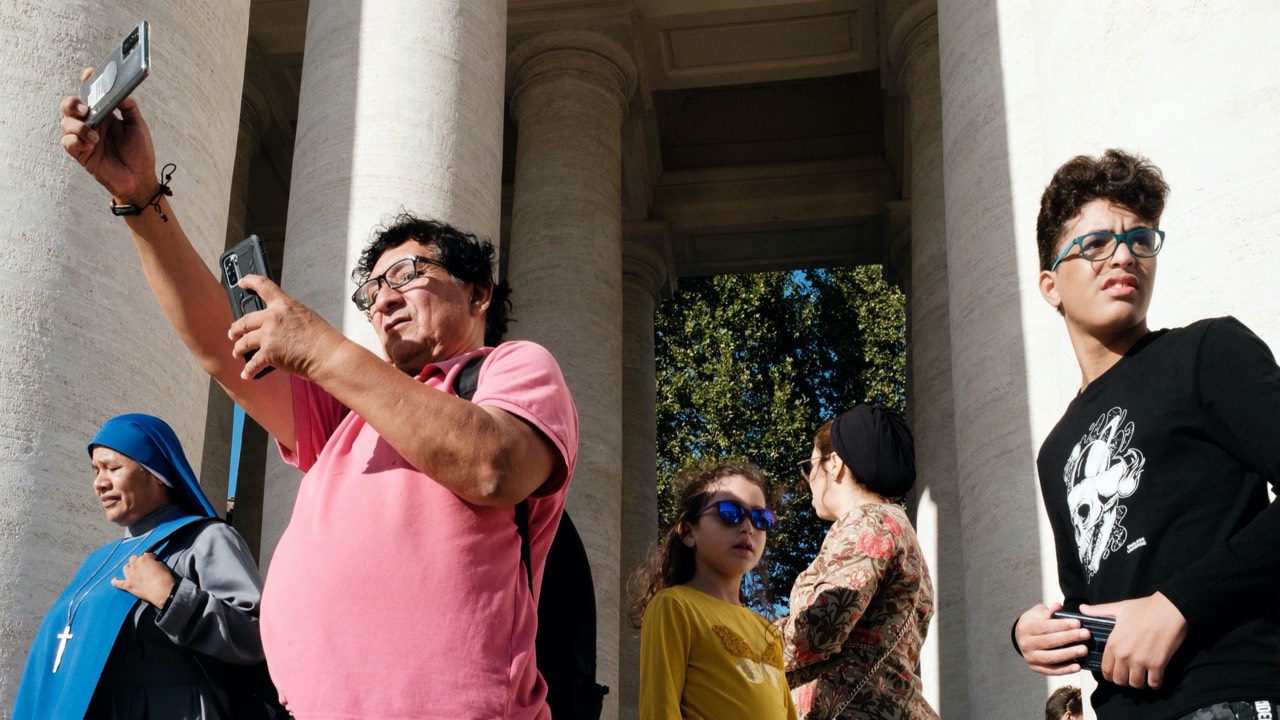 street photography in rome featuring a line-up of 5 people — a nun, a tourist, a girl, a woman, and a teenage boy