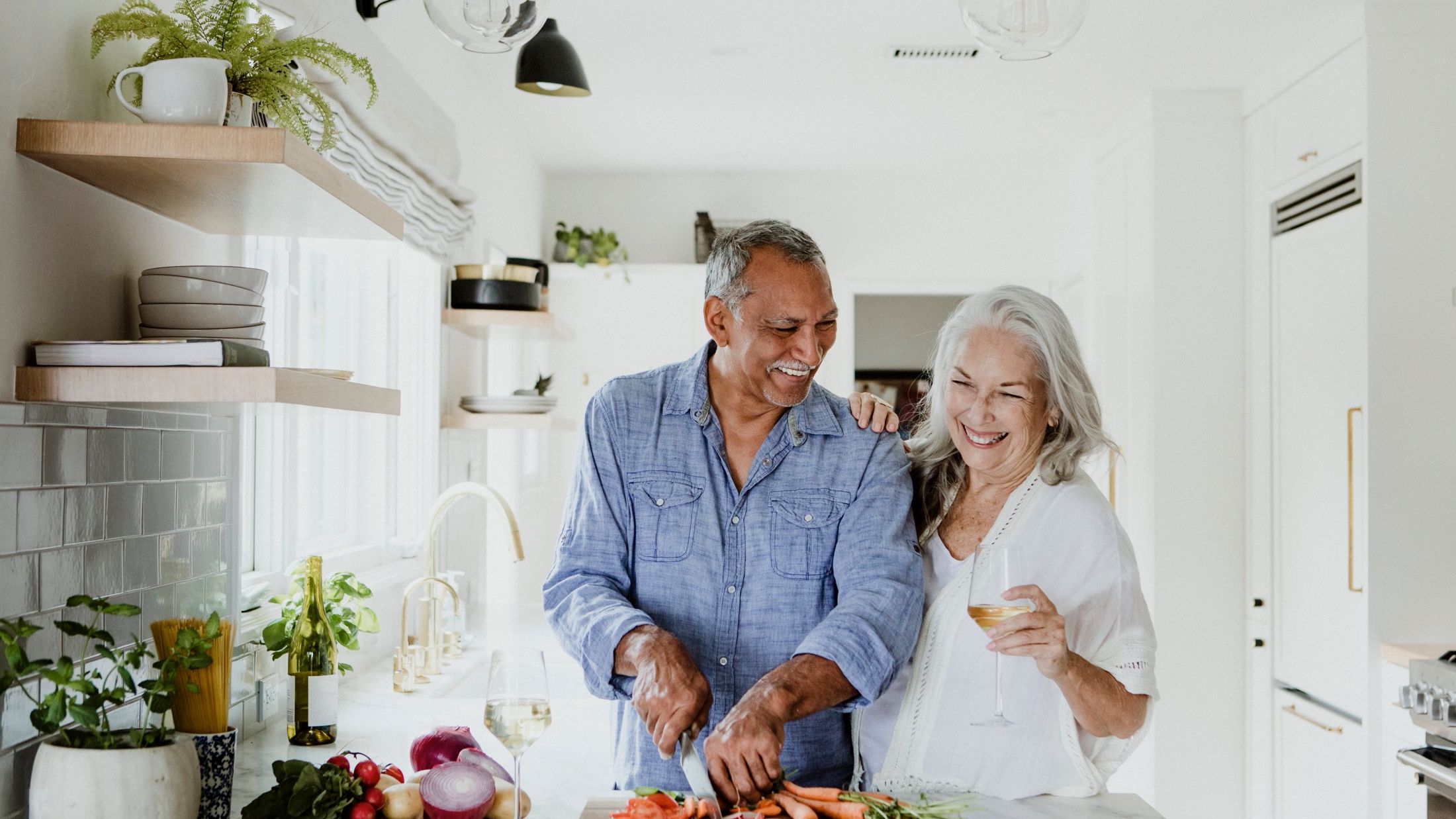 Older couple preparing healthy meal in kitchen