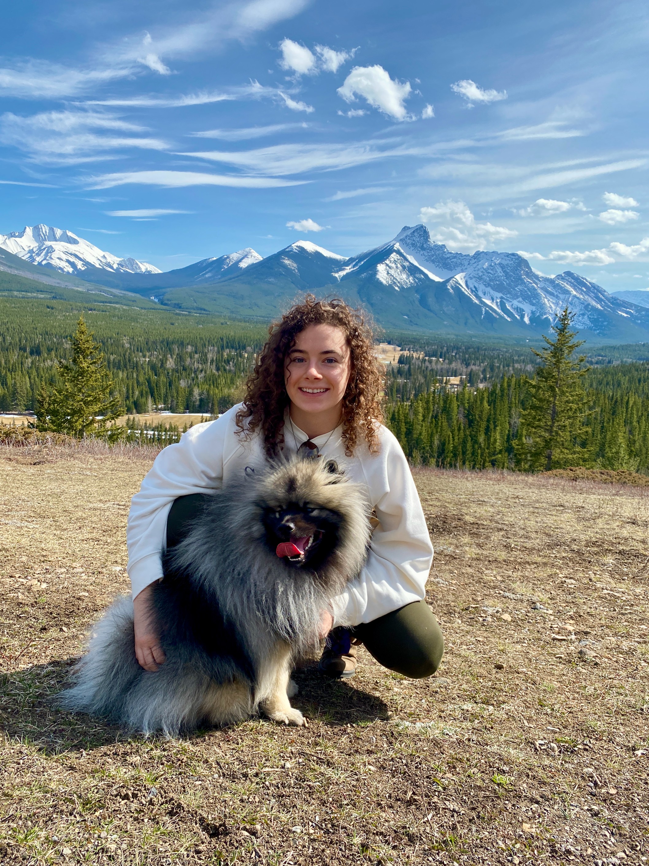 Dr. Mikayla Schmolke with her dog in the mountains