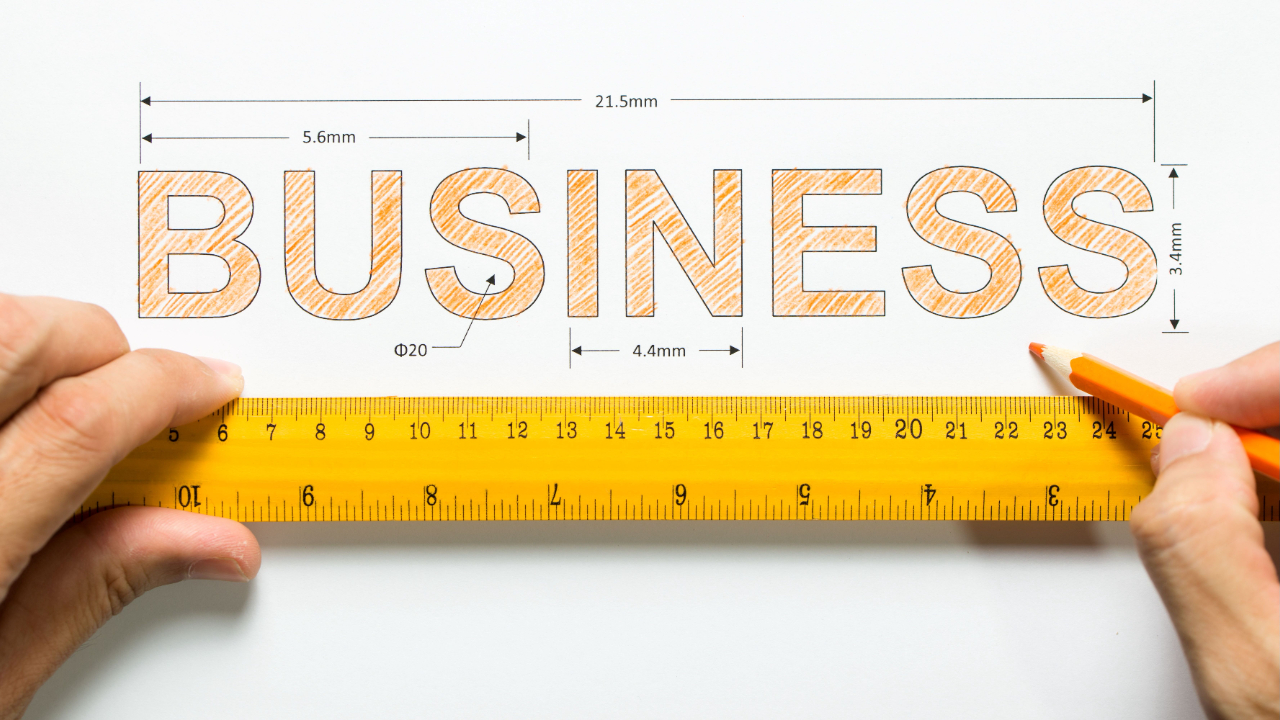 The word business written on a paper with a ruler and font size dimensions listed