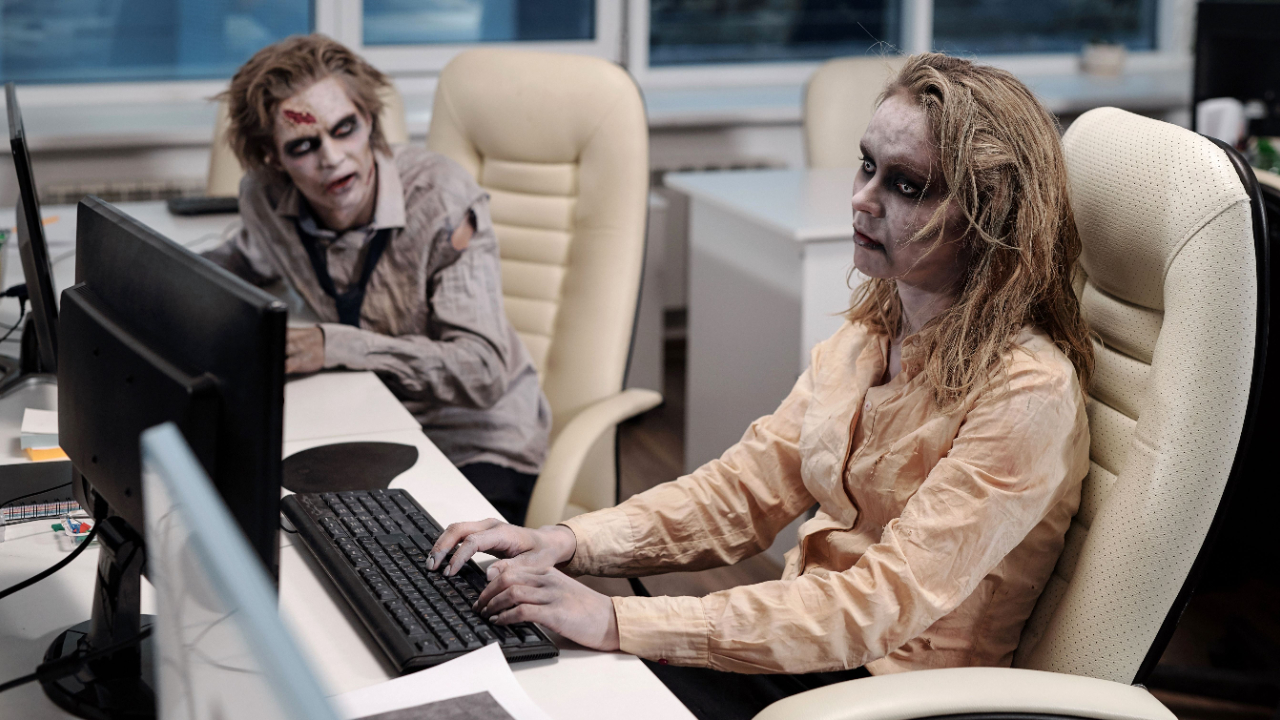 Zombie workers typing on computers