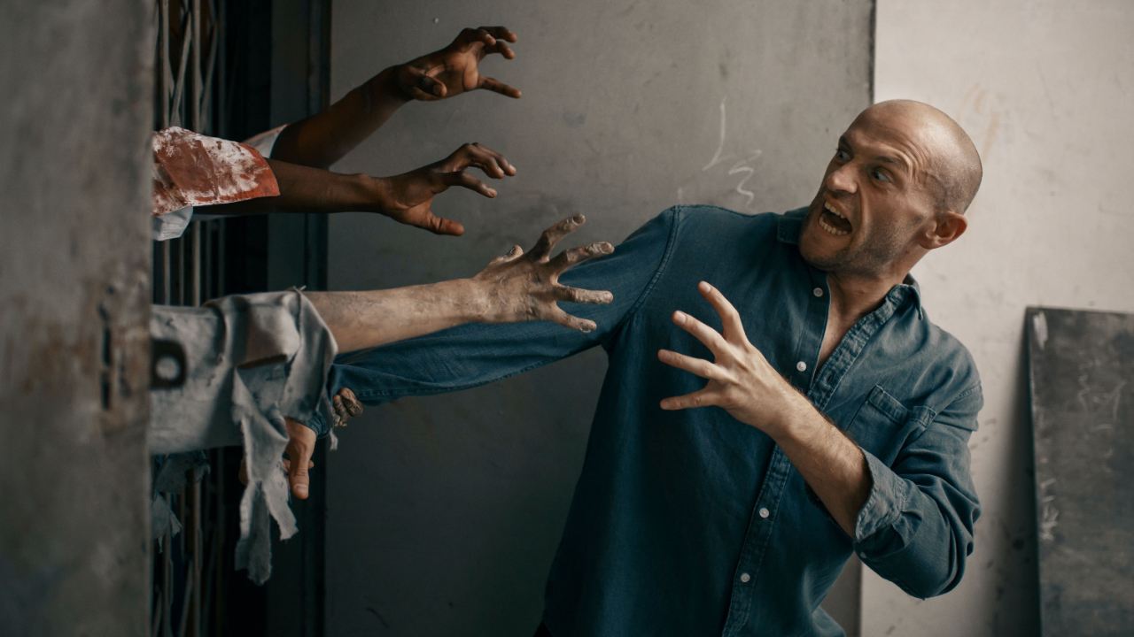 Business man being grabbed by zombies