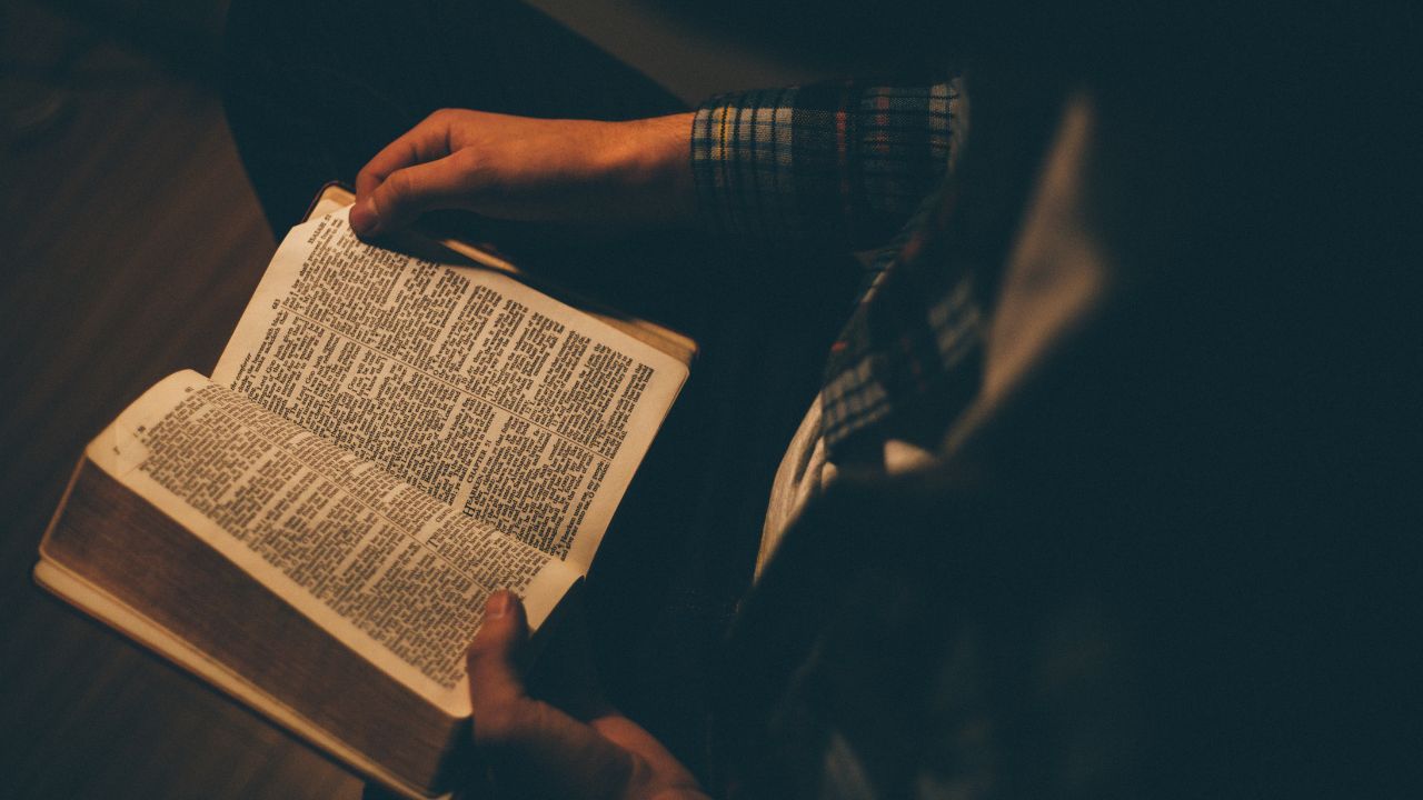 Pastor reading a Bible to figure how what the Bible says about bi-vocational pastors