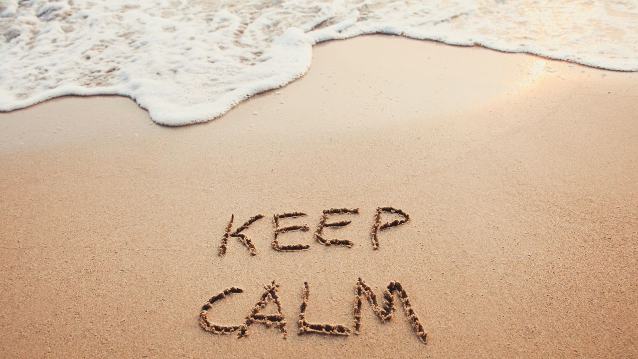 keep calm written on sand