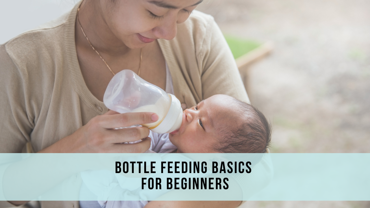 A newborn baby is drinking from a bottle while being held by the mother.