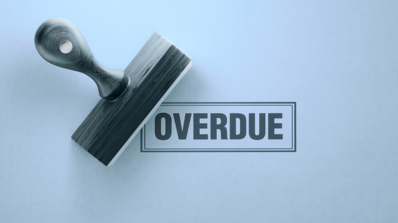 rubber stamp pressing the word overdue on a surface, symbolizing the hidden cost of chronic overdoing, depletion, and pressure building beneath sustained effort