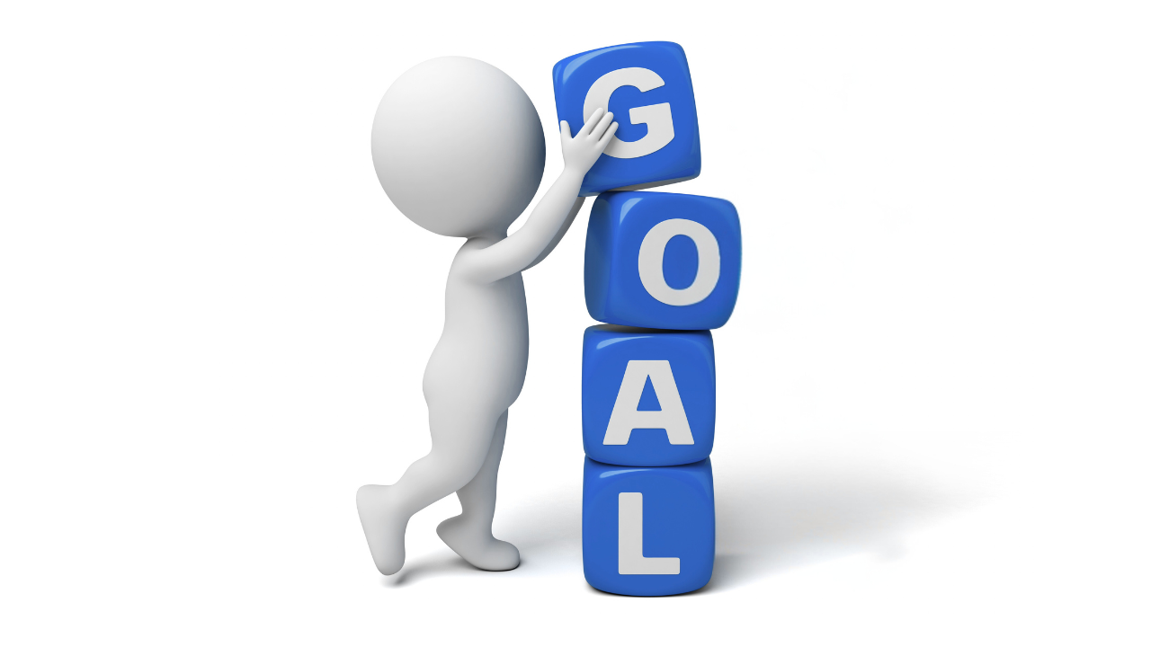 figure stacking blocks that spell goal, representing how physical action and health support achieving goals and leadership success
