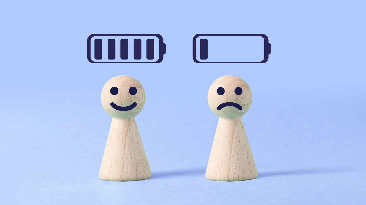 two simple wooden figures showing full and low energy with battery icons above them, representing how daily energy habits influence steadiness and depletion over time