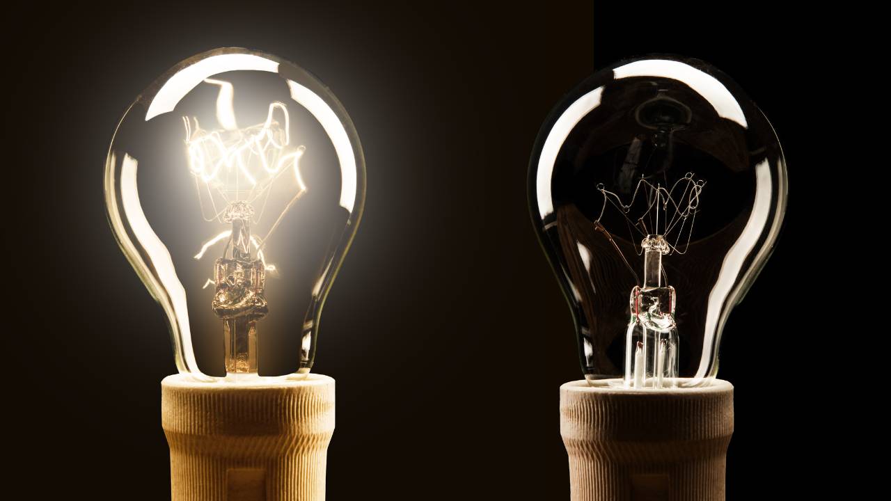 two light bulbs side by side, one glowing brightly and one dim, symbolizing the body sensing energy shifts before the mind notices